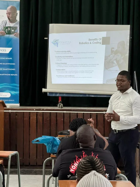 A facilitator presenting to learners in a classroom